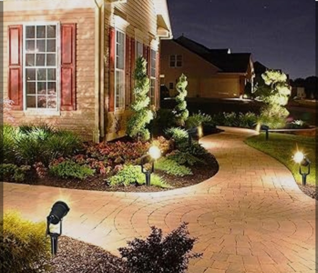 Path and accent lighting on residential brick walkway at night