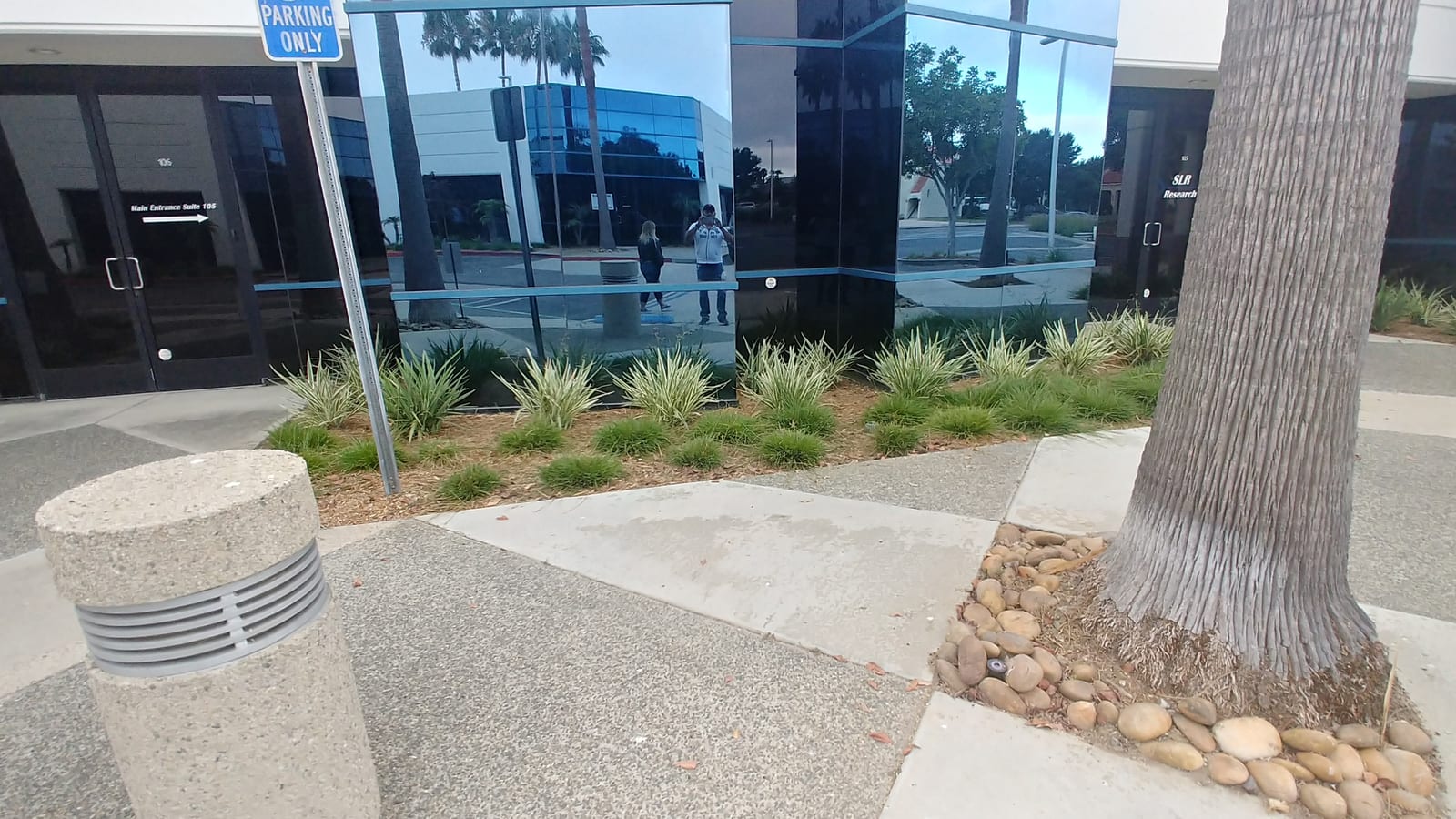 Corner office plantings with stone detail and bollard