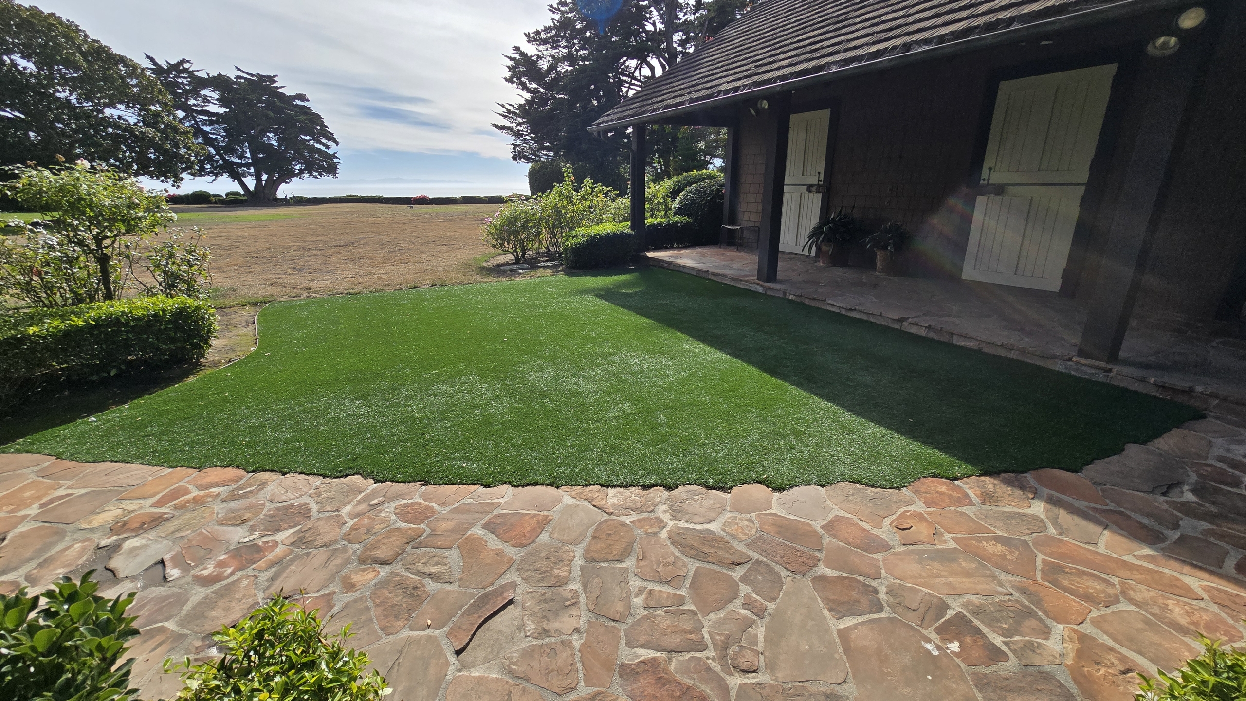 Country home with maintained turf and stone walkway